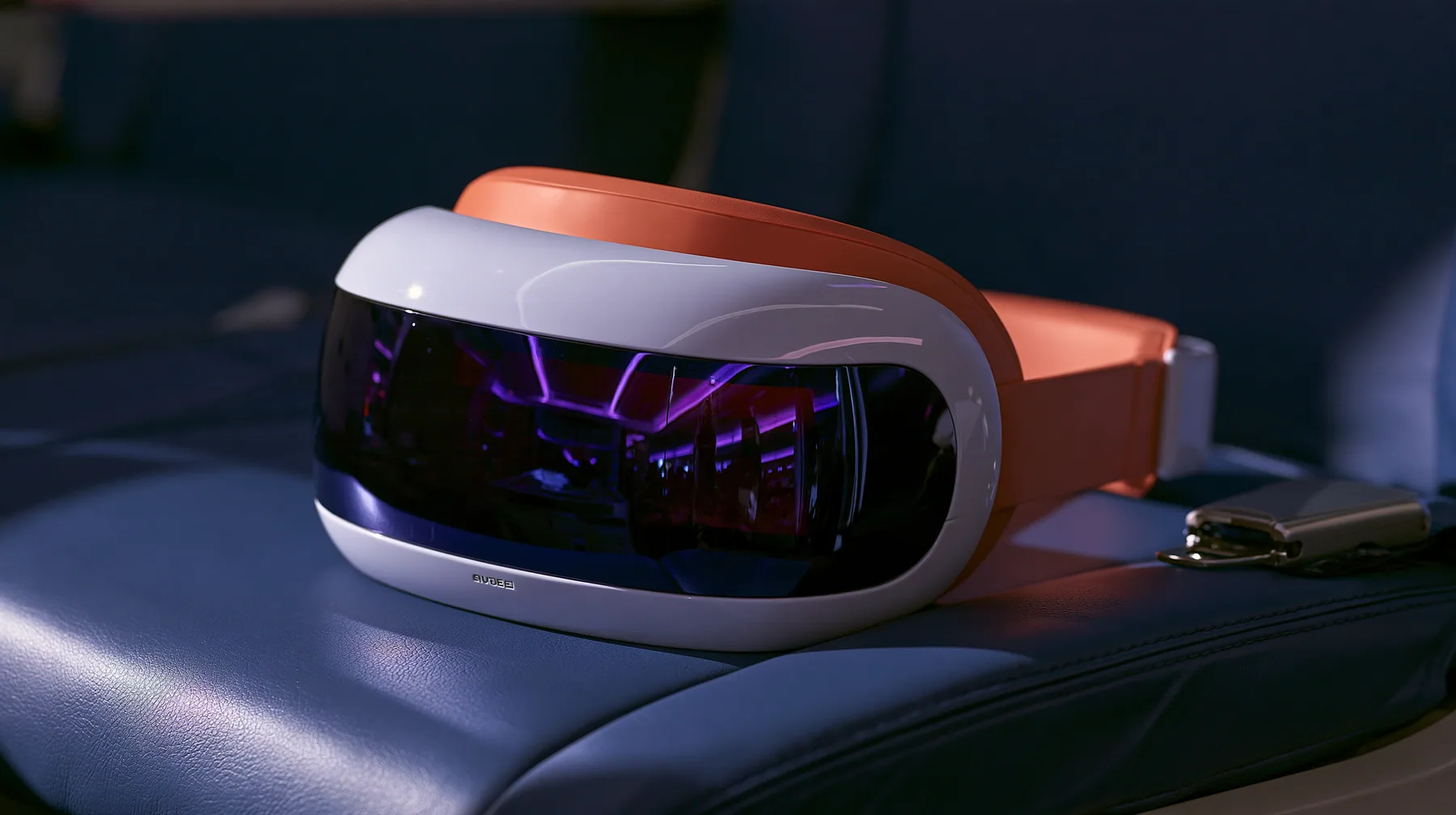 Jet-set editorial product still life: a sleek glossy white virtual-reality headset visor with a clay-orange band resting on a navy leather airplane seat at night, the glossy black front glass reflecting violet cabin…