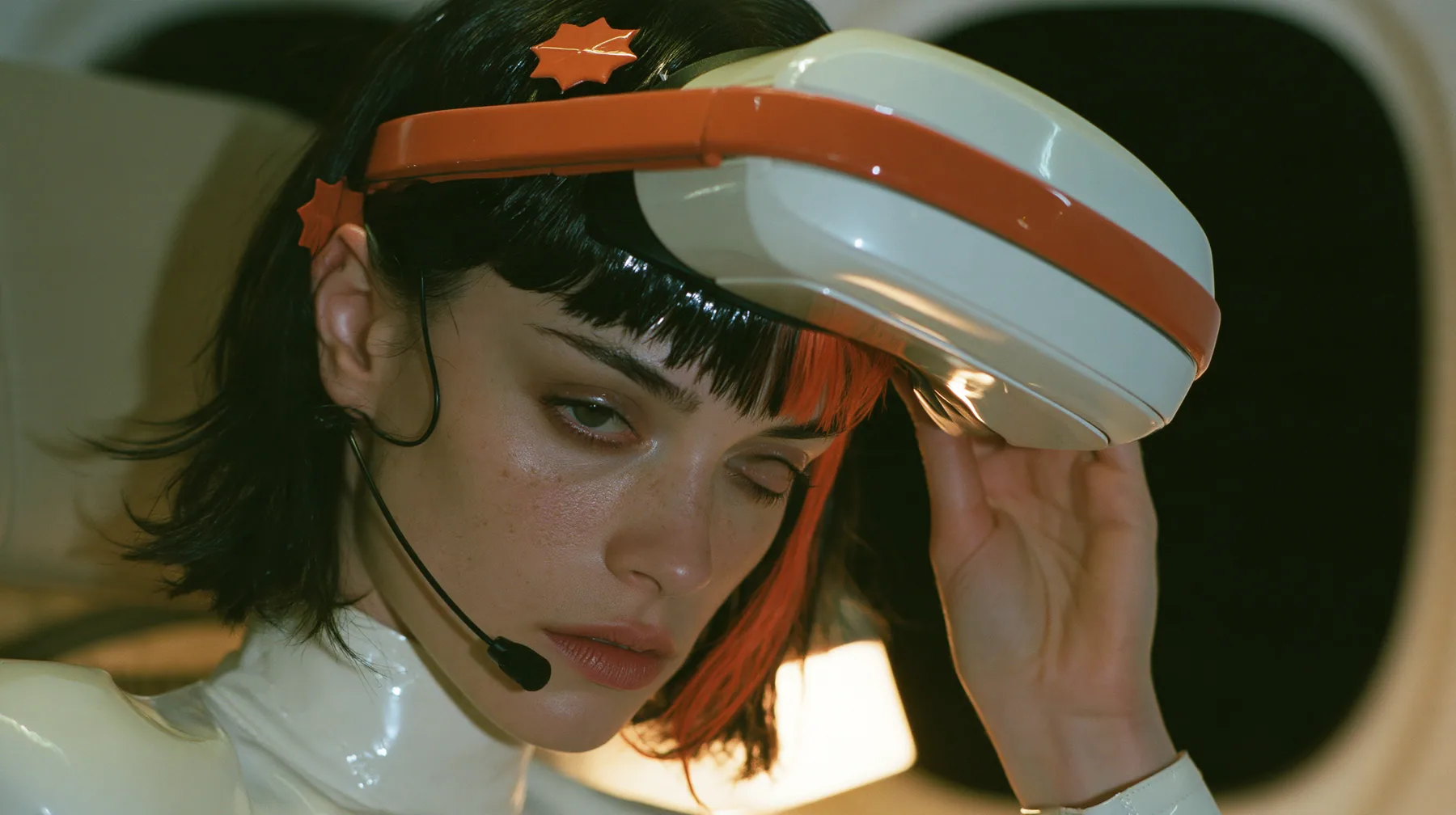 Jet-set high fashion editorial, a couture magazine story shot on a night flight: a close-up of a Caucasian American woman in her late twenties with a grown-up angular face, defined cheekbones and a strong jawline,…