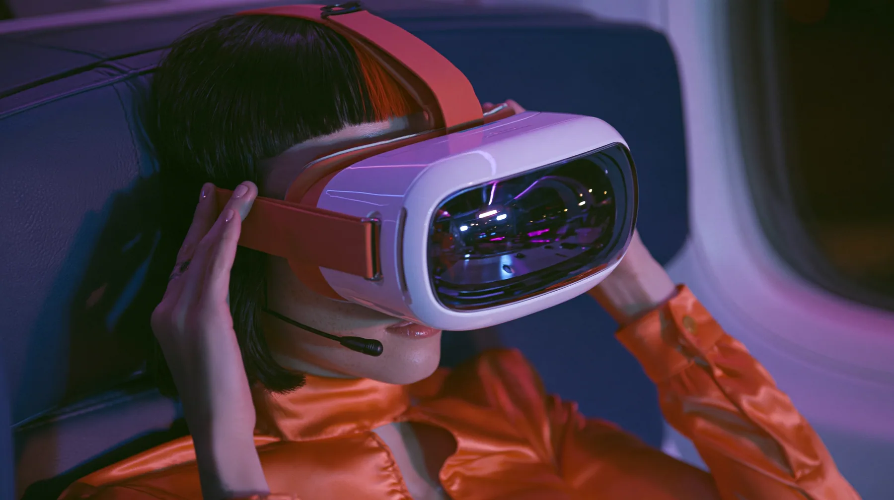Jet-set fashion editorial, night flight: a medium close-up of a Caucasian American woman in her late twenties with pale skin and a glossy black blunt bob with heavy straight bangs and one clay-orange streak, a thin…