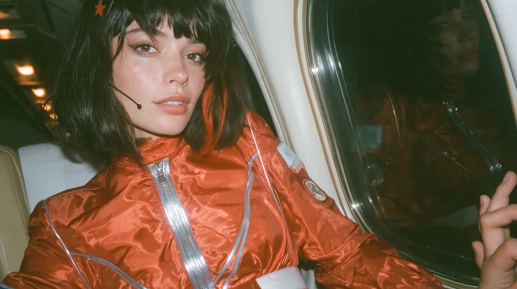 Jet-set fashion editorial, night flight: an eye-level close three-quarter profile of a Caucasian American woman in her early thirties, a grown woman with elegant mature features, an angular face and defined…
