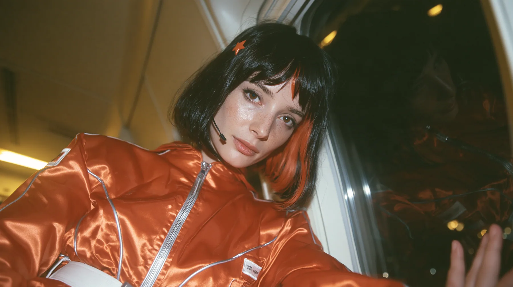 Jet-set fashion editorial, night flight: an eye-level close three-quarter profile of a Caucasian American woman in her early thirties, a grown woman with elegant mature features, an angular face and defined…