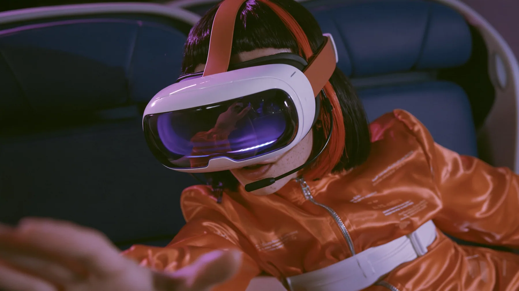 Jet-set fashion editorial, night flight: a Caucasian American woman in her early thirties, an angular adult face, pale freckled skin, a glossy black blunt bob with heavy bangs and one clay-orange streak, a thin black…