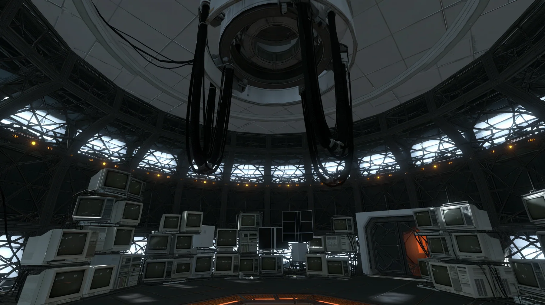 Portal 2 (2011) Source engine screenshot, Valve, the empty Aperture Science central AI chamber: the ceiling ring mount with thick black cables hanging down, dozens of old CRT monitors and flat panel screens stacked…