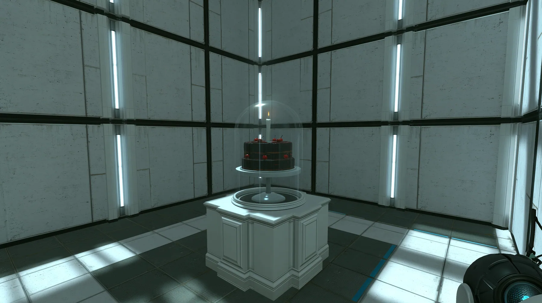 Portal 2 (2011) Source engine screenshot, Valve, a clean Aperture Science test chamber of white concrete panels with black seams and vertical light strips, a black forest chocolate cake with cherries and one lit…