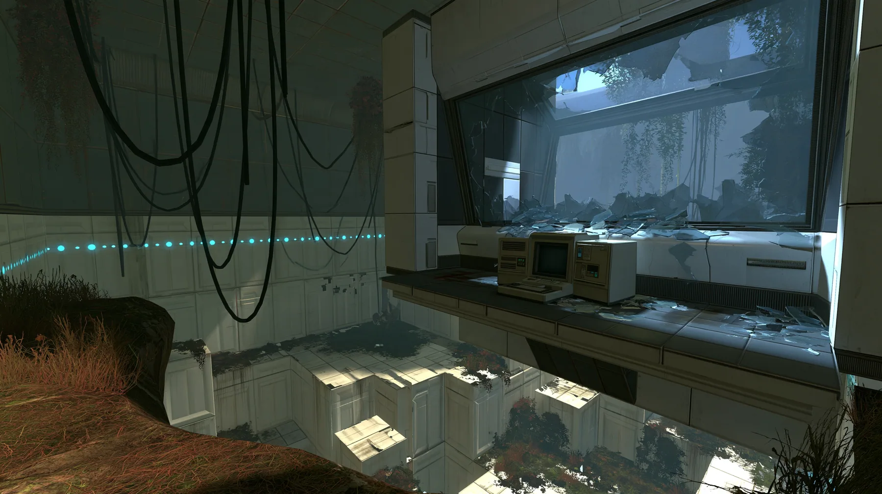 Portal 2 (2011) Source engine screenshot, Valve, an Aperture Science observation booth high above a test chamber, its big window smashed, glass shards on the console and floor, the decaying white panelled chamber…