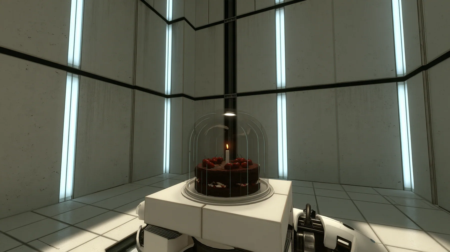 Valve's Portal 2 (2011), a Source engine screenshot: a clean Aperture Science test chamber of white concrete panels with black seams and vertical light strips, a black forest chocolate cake with cherries and one lit…