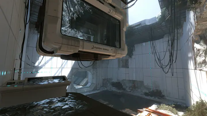 Valve's Portal 2 (2011), a Source engine screenshot: an Aperture Science observation booth high above a test chamber, its big window smashed, glass shards on the console and floor, the decaying white panelled chamber…