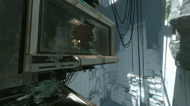 Valve's Portal 2 (2011), a Source engine screenshot: an Aperture Science observation booth high above a test chamber, its big window smashed, glass shards on the console and floor, the decaying white panelled chamber…