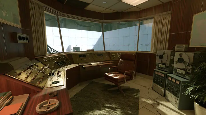 Valve's Portal 2 (2011), a Source engine screenshot: old 1960s Aperture Science: Cave Johnson's wood-panelled observation booth, brass controls and toggle switches, reel-to-reel tape machines, an ashtray, a leather…