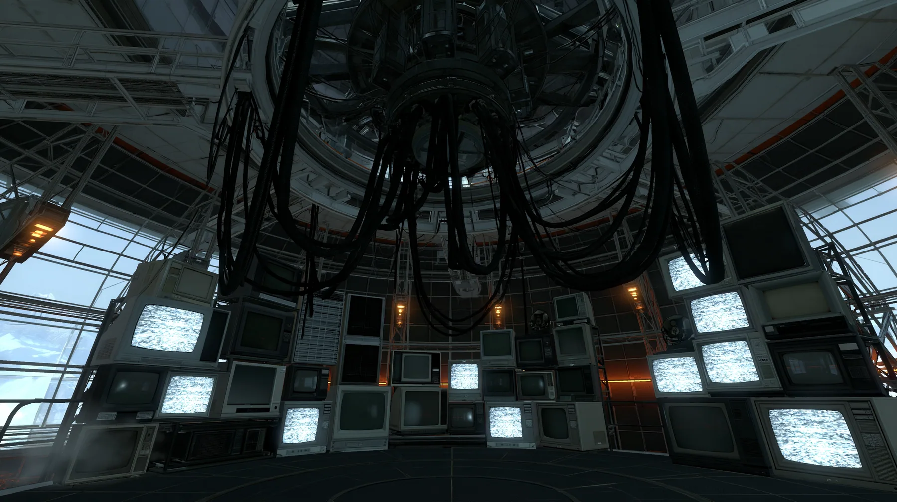 Portal 2 (2011) Source engine screenshot, Valve, GLaDOS's dark central AI chamber: the empty ceiling ring mount with thick black cables hanging down, dozens of old CRT monitors, TVs and panel displays stacked around…