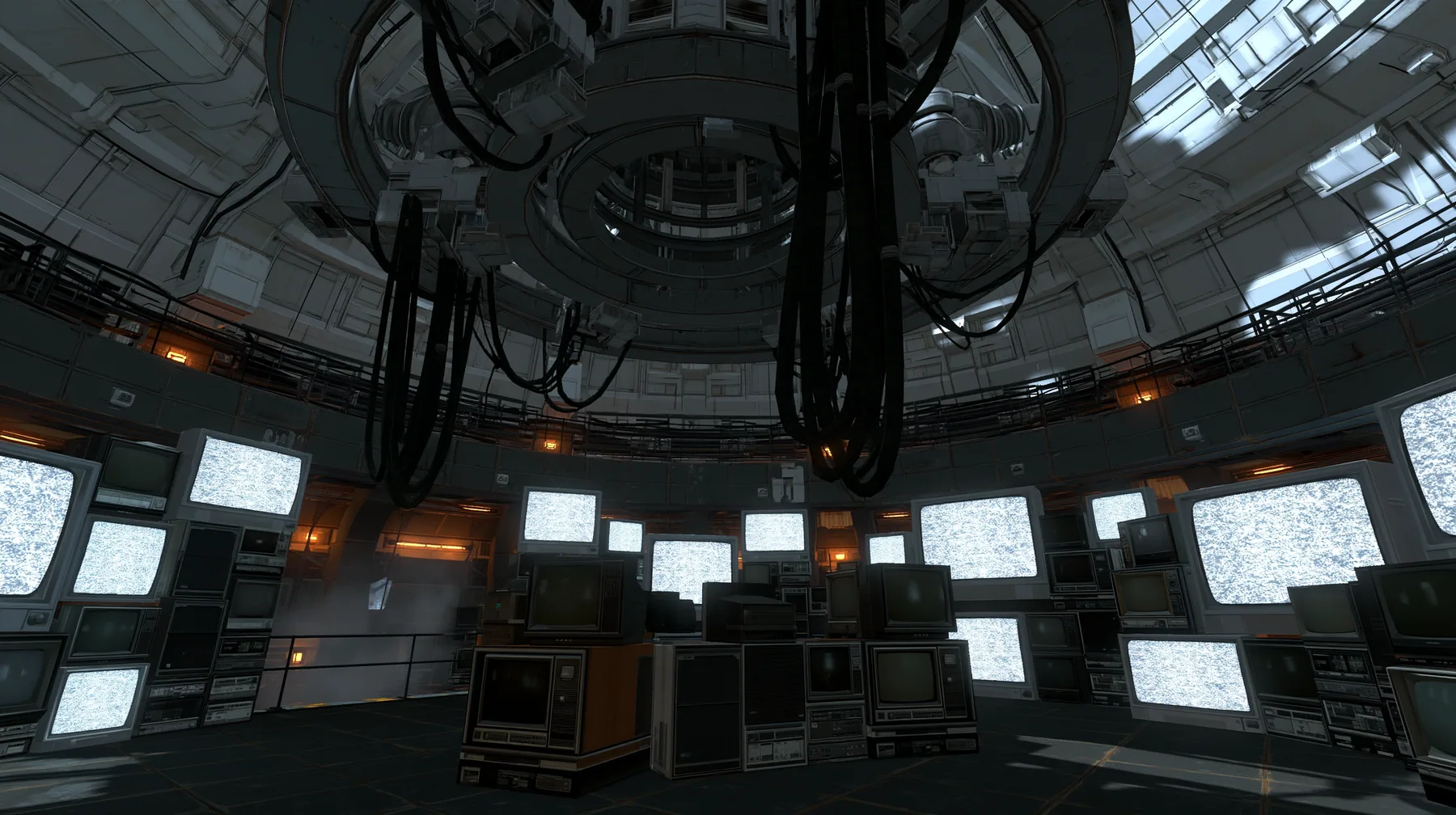 Portal 2 (2011) Source engine screenshot, Valve, GLaDOS's dark central AI chamber: the empty ceiling ring mount with thick black cables hanging down, dozens of old CRT monitors, TVs and panel displays stacked around…