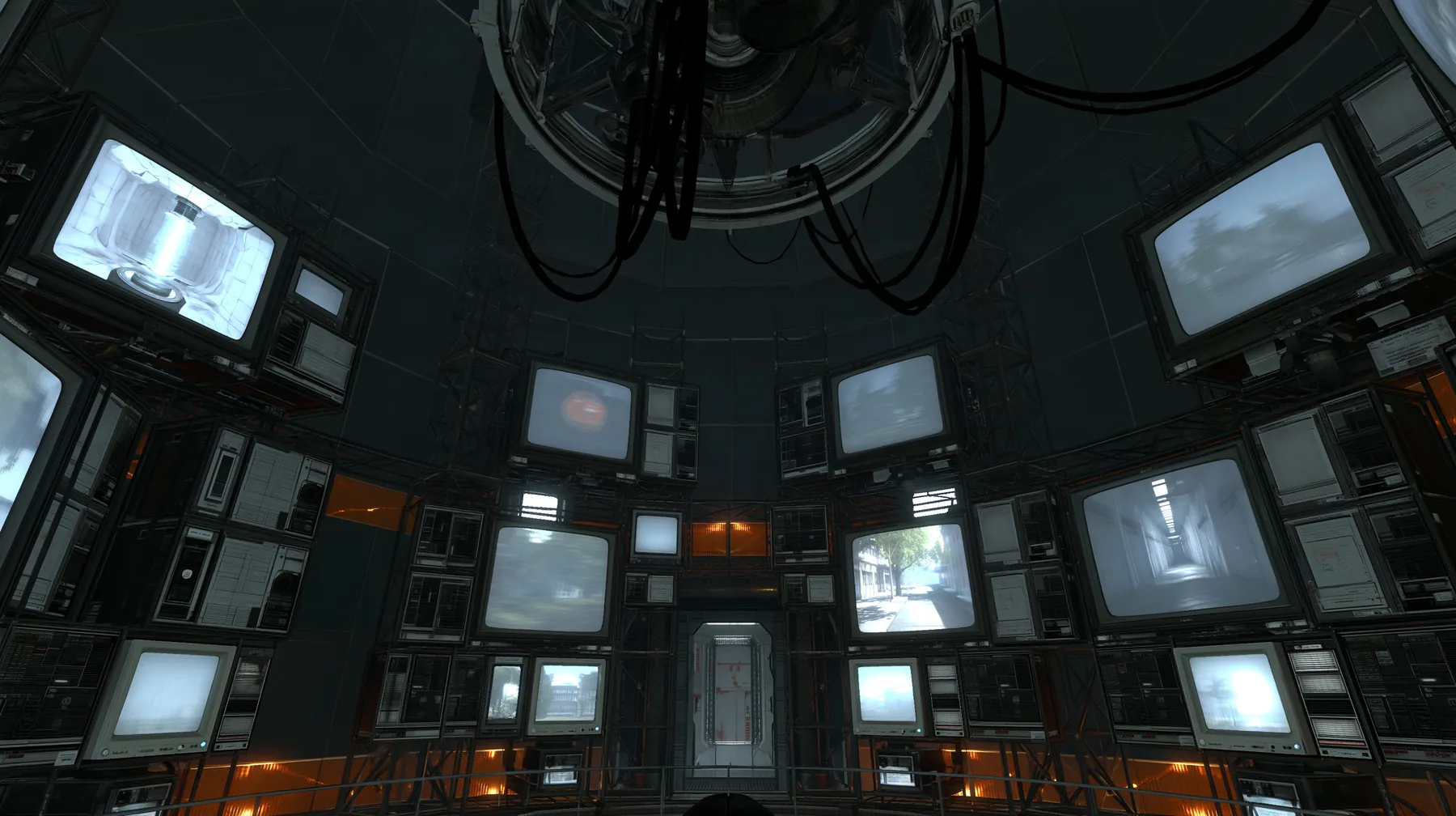 Portal 2 (2011) Source engine screenshot, Valve, GLaDOS's dark central AI chamber: the empty ceiling ring mount with black cables, dozens of old CRT monitors and panel displays around the curved walls, each screen…