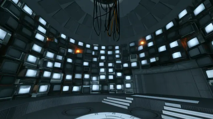 Remove the hanging robot, leaving only the white ceiling ring and its black cables hanging empty, and line the curved walls of the chamber with dozens of old CRT monitors and flat panel screens stacked floor to…
