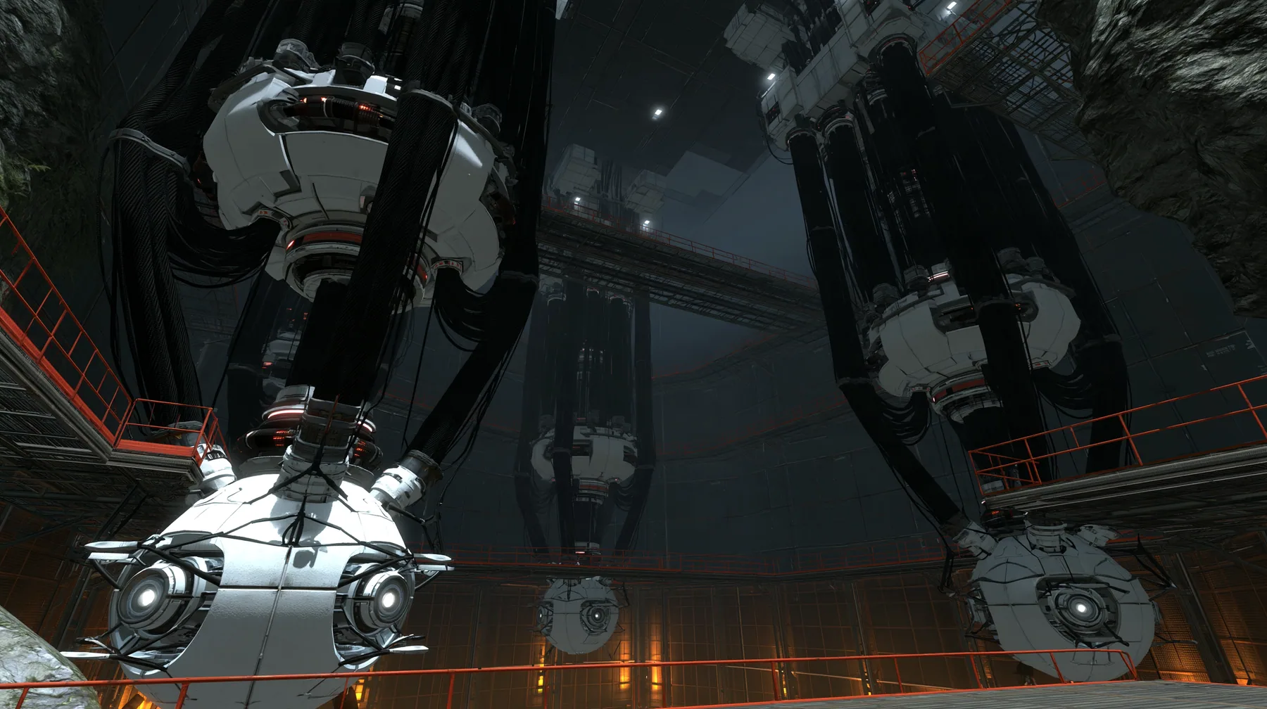 Portal 2 (2011) Source engine screenshot, Valve, a colossal Aperture Science AI core chamber: giant white spherical cores with glowing optics hanging from enormous black cable trunks in a vast dark shaft, catwalks,…
