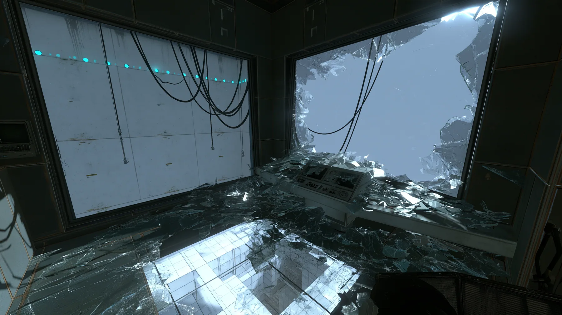 Valve's Portal 2 (2011), a Source engine screenshot: a dark observation booth of the test facility high above a white test chamber, its big window smashed outward, glass shards across the console and the floor, the…