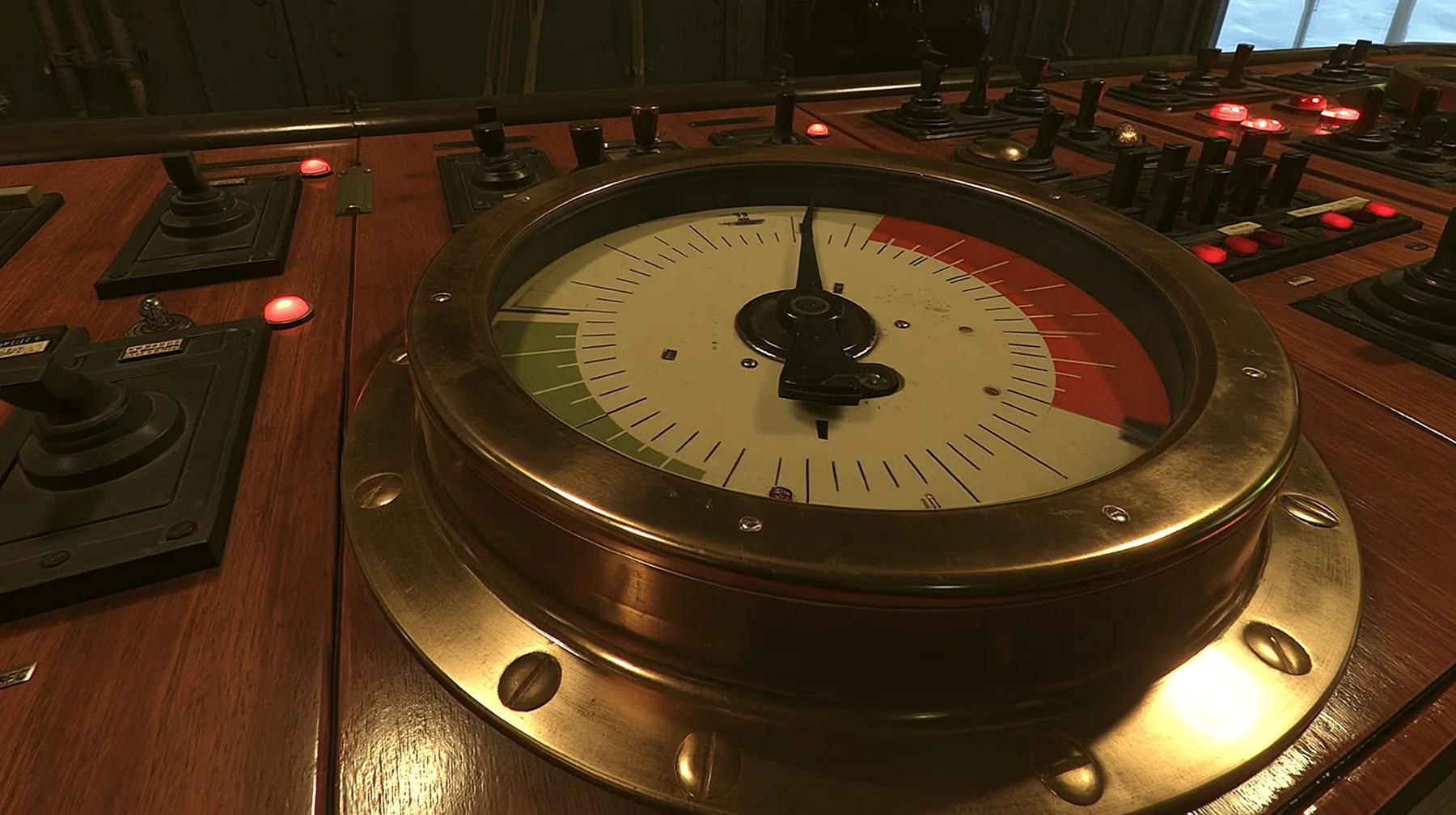 macro close-up of a big brass-bezelled analog gauge on a wooden 1960s control console: a cream dial face with a red zone at the upper right and a green zone at the left, plain tick marks, the black needle trembling…