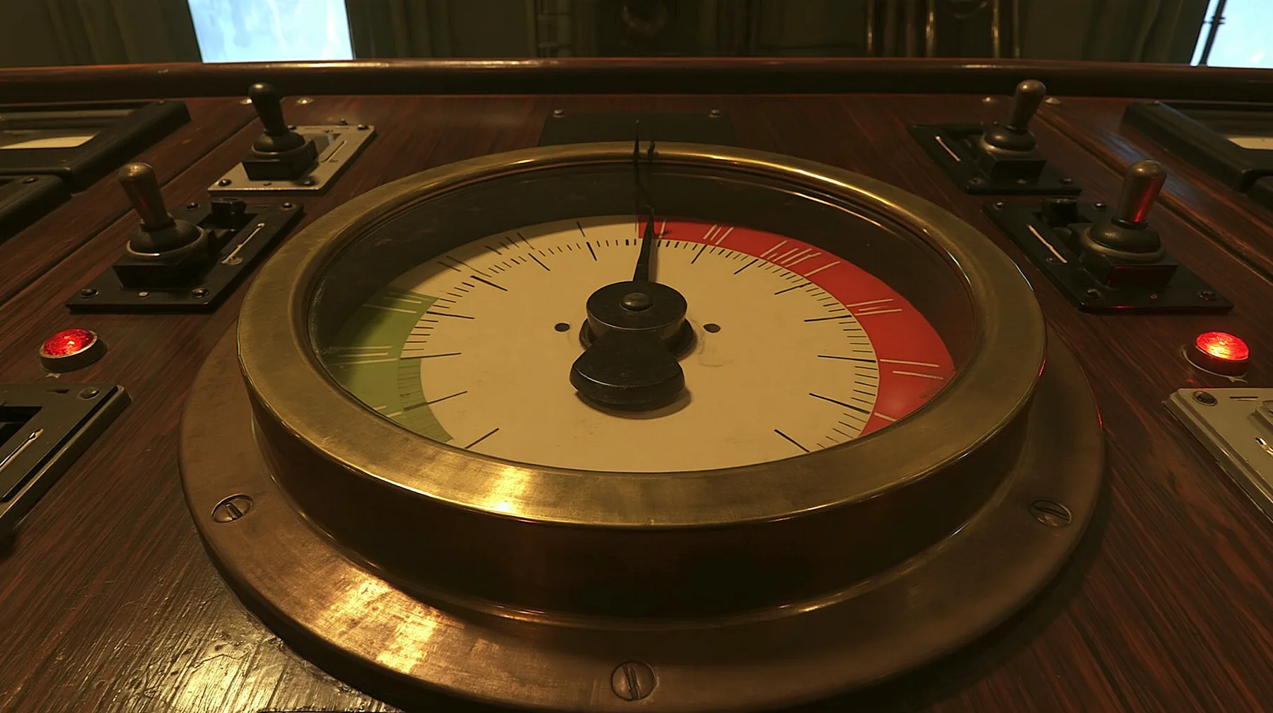 macro close-up of a big brass-bezelled analog gauge on a wooden 1960s control console: a cream dial face with a red zone at the upper right and a green zone at the left, plain tick marks, the black needle trembling…