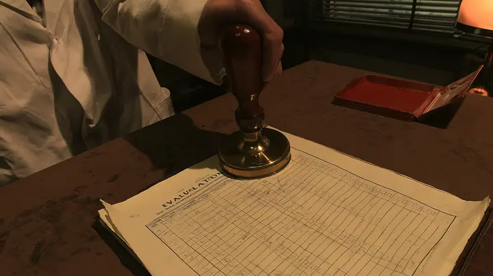 Macro cinematic film still at desk level in a 1970s Aperture office: an official cream evaluation form with rows of pencil-ticked boxes lies on a worn brown desk, and above it, filling the top of the frame, a big…