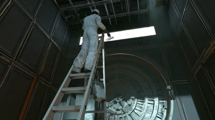 Low-angle cinematic film still: a technician in white overalls and cap, seen from behind on a tall aluminium ladder, rolls white paint across a long backlit sign above a massive round vault door in a dark panelled…