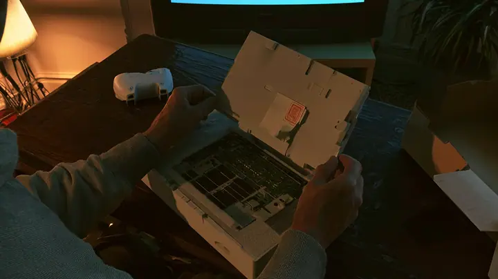 Top-down cinematic film still: on a dark wooden coffee table hands in a grey hoodie pull the cover off a new white game console in its foam tray, its circuit board bare with empty memory slots and a little paper slip…