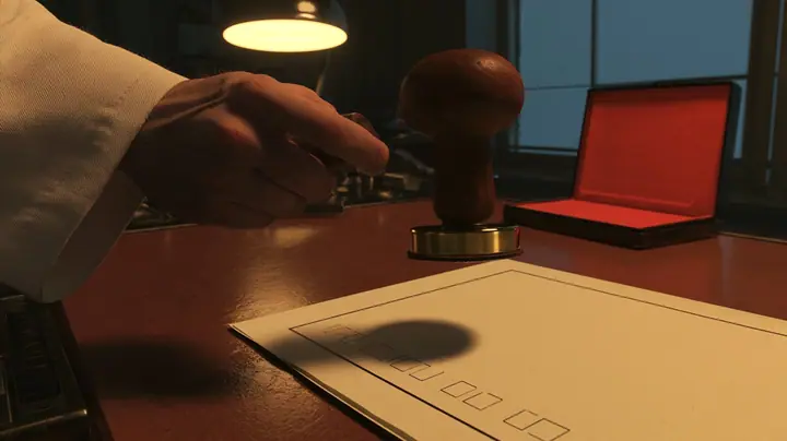 Macro cinematic film still: a heavy wood-handled rubber stamp with a brass collar, held by a hand in a white lab coat sleeve, hovers over a cream form with empty tick boxes on a polished brown desk, an open red ink…