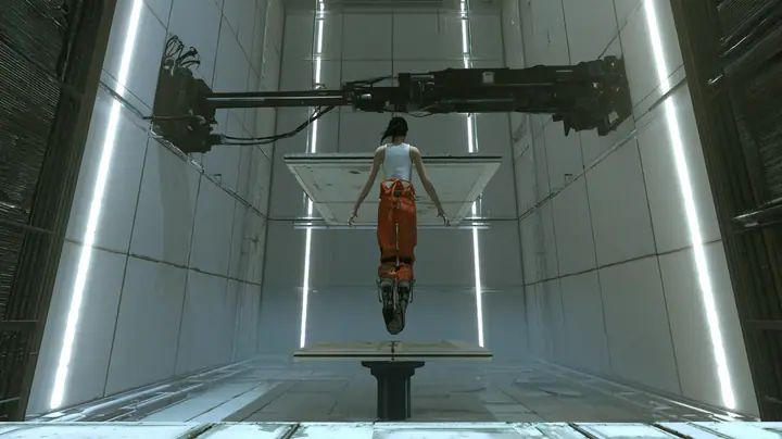 dramatic low-angle film still inside a tall white Portal 2 test chamber: at the top of her flight a woman in a white tank top and an orange jumpsuit tied at the waist, dark ponytail, long-fall boots, seen from behind…