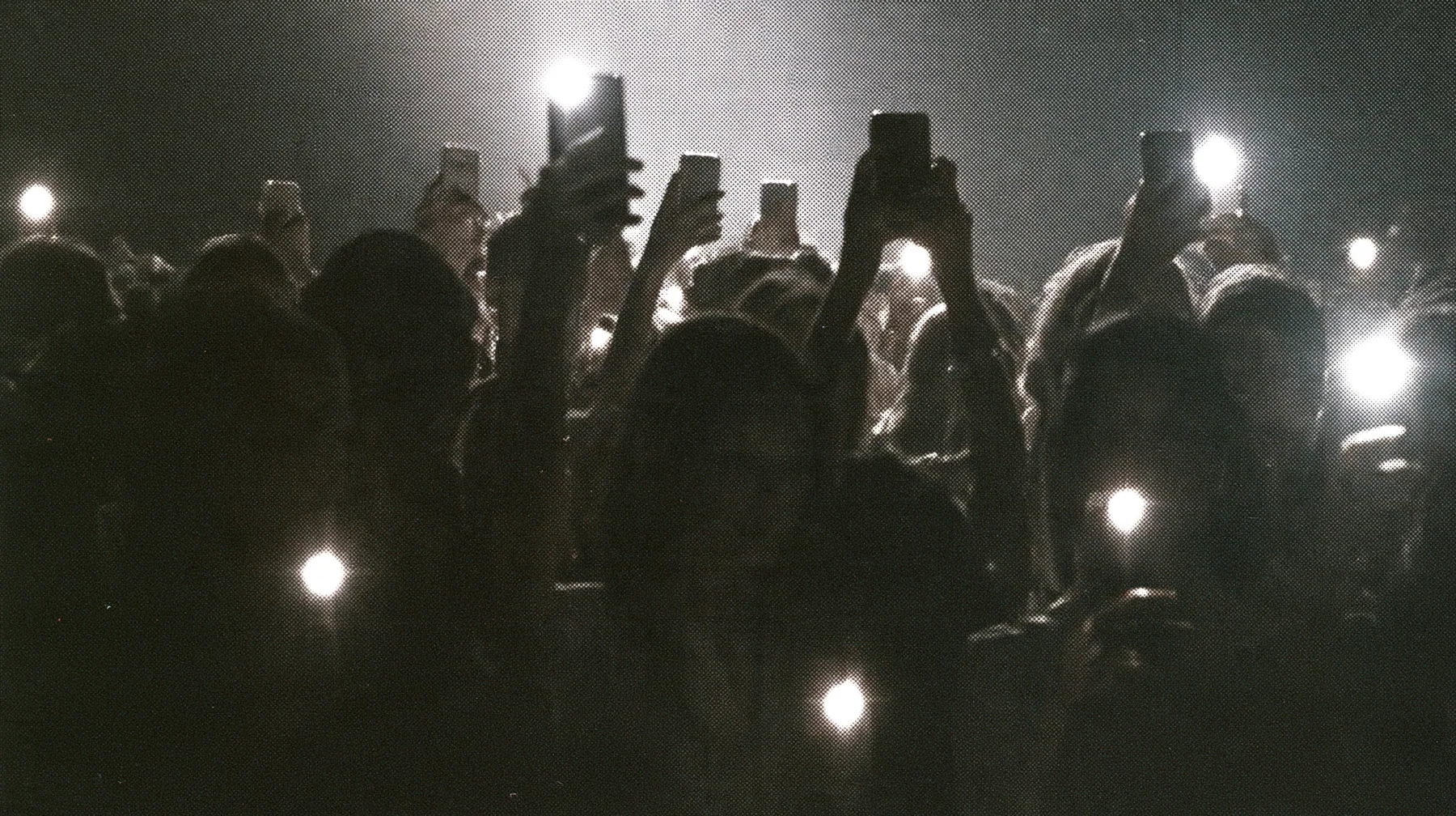 a 1-bit ordered-dither photocopy of a crowd of silhouetted fashion-show guests holding up glowing phones, coarse dither in black toner on off-white paper, copier edge burn, one scanline drop-out band, no grey tones,…