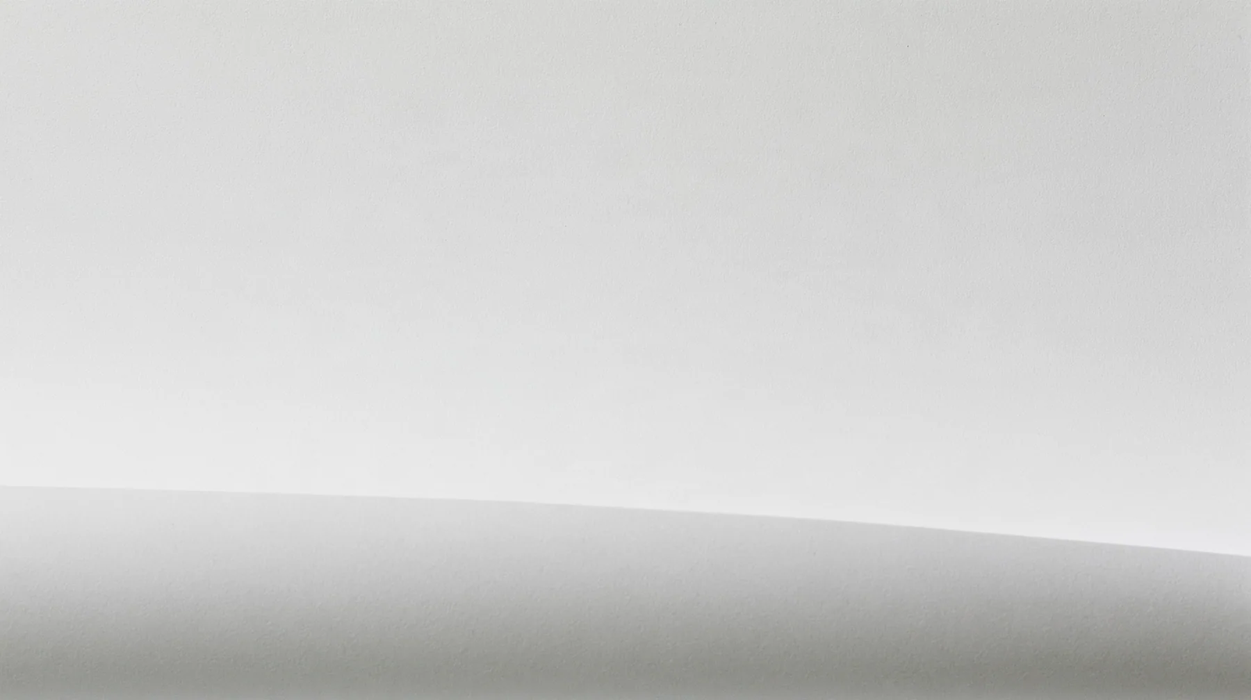 an empty sheet of grey xerox paper photographed flat, toner grain and faint scanner streaks, a hairline crop mark and a registration target near one corner, a soft fold across the lower third, a large calm field for…