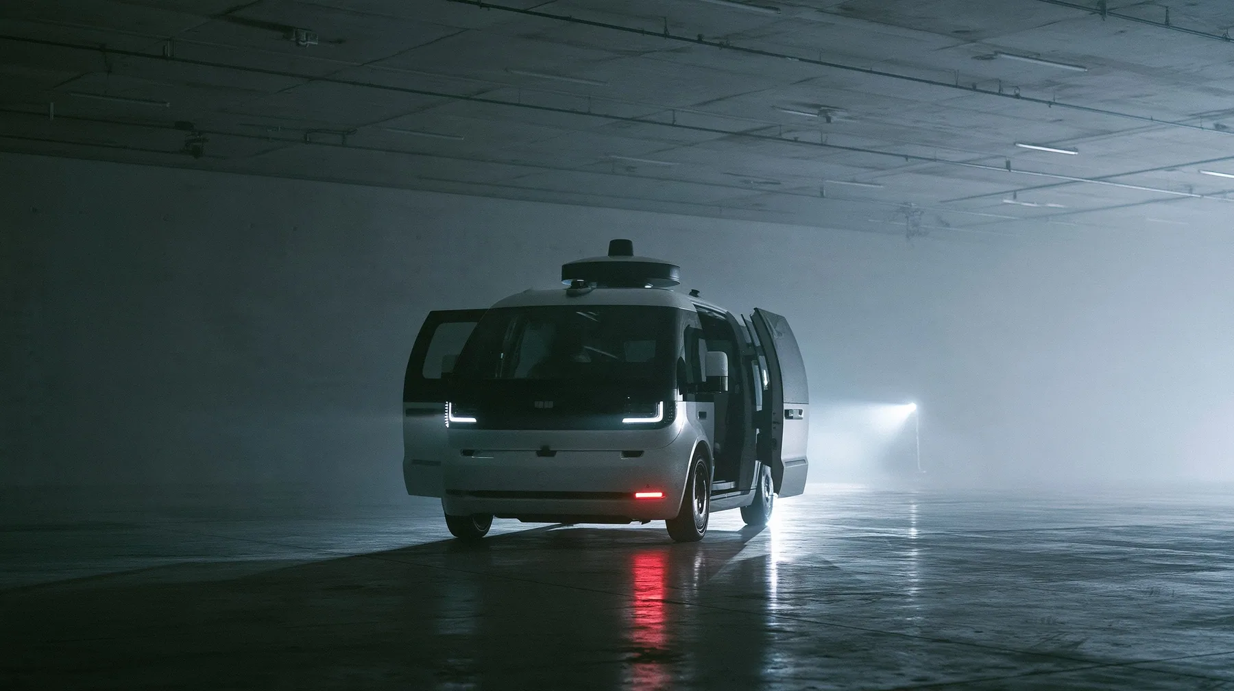a driverless white robotaxi with a spinning roof sensor pulled up at the end of a fashion catwalk inside a foggy concrete hall, doors open, headlights cutting through fog like show lights, monochrome, one red brake…