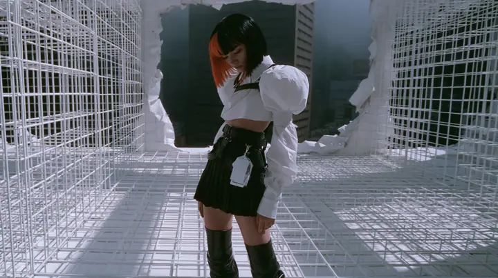 a white wireframe grid test arena floor and walls peeling away like paper to reveal a dark foggy city behind, a young woman with a glossy black blunt bob with heavy bangs and one clay-orange streak, a white cropped…