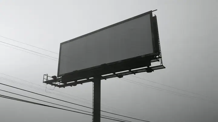 looking up at a huge blank white billboard on a steel pole above the 101 freeway at dawn in thick fog, the billboard face flat and empty, powerlines, grey sky, monochrome, fine grain, no text, no letters, no logos