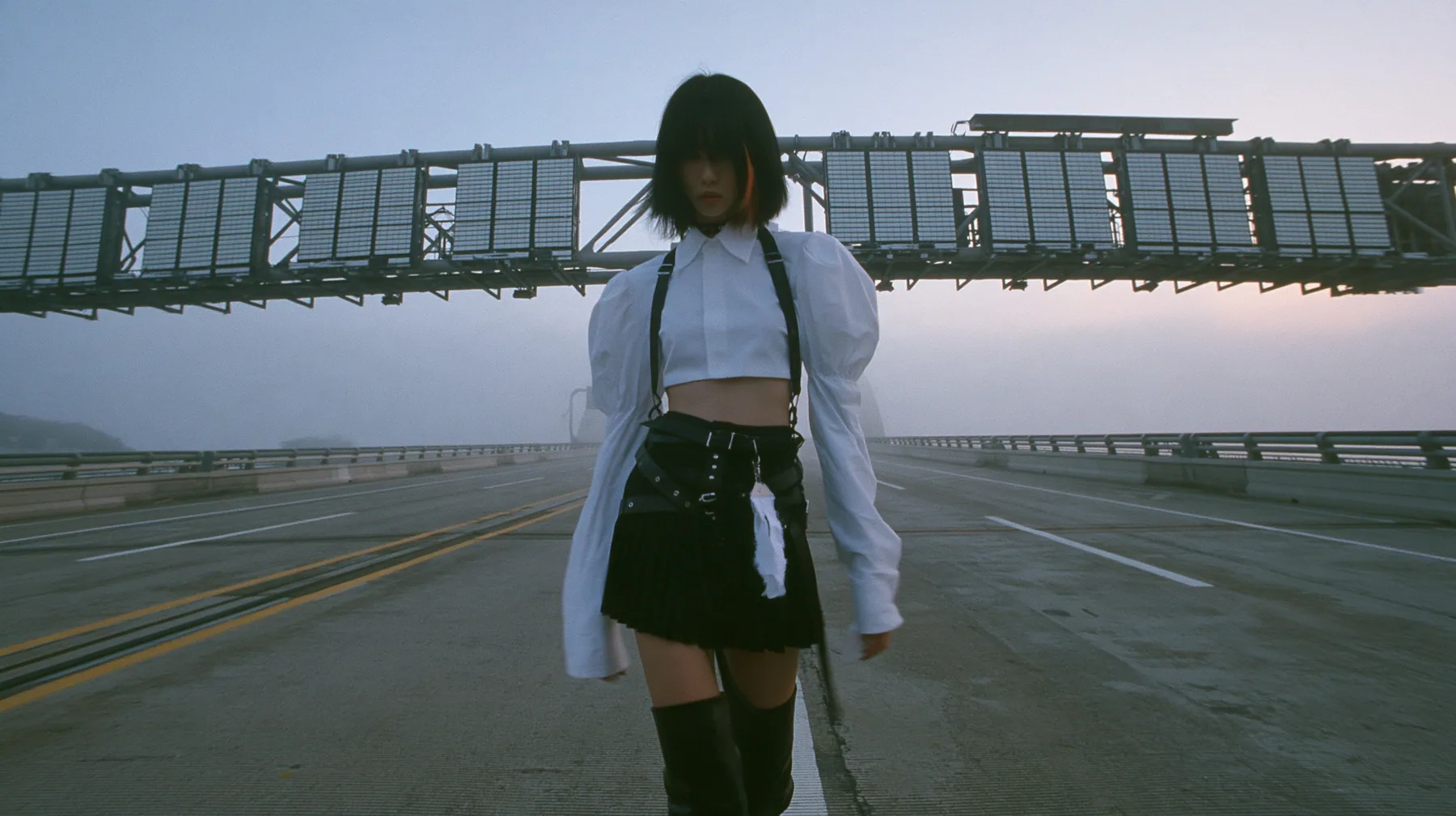 a young woman with a glossy black blunt bob with heavy bangs and one clay-orange streak, a white cropped puff-sleeve shirt, a black pleated skirt with a harness belt and a hanging white garment tag, black knee-high…