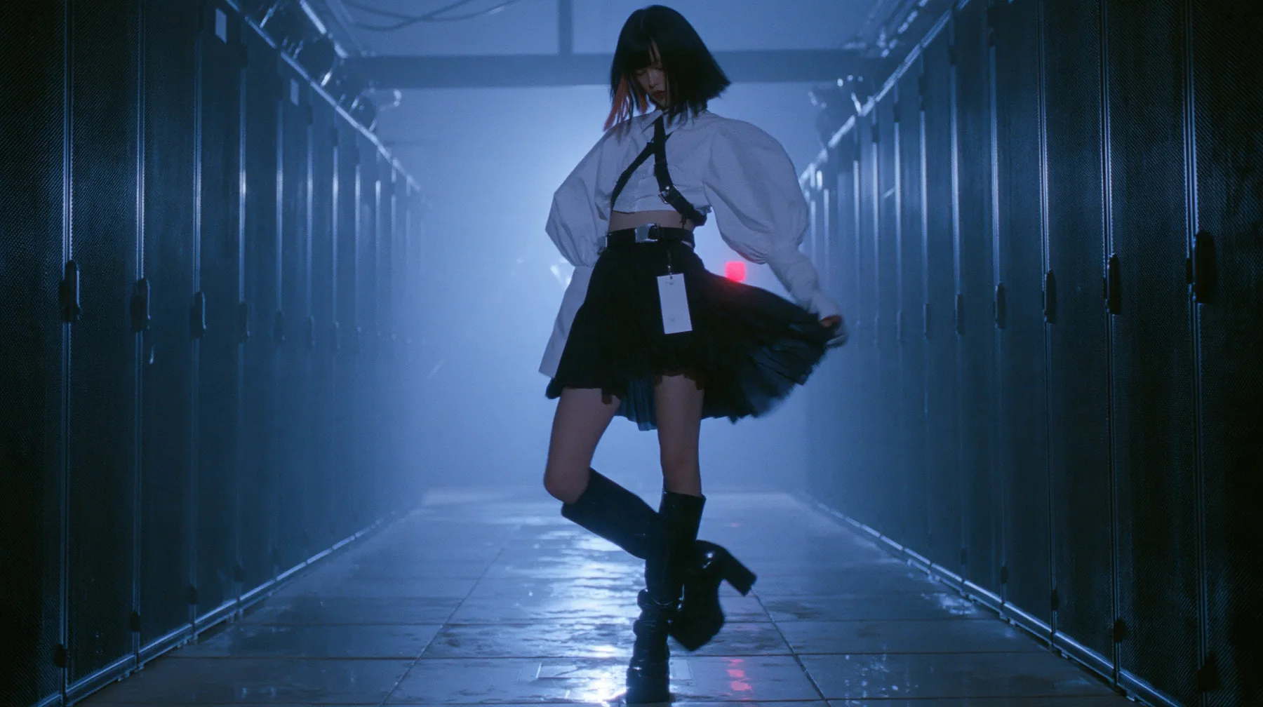 full-length shot of a young woman with a glossy black blunt bob with heavy bangs and one clay-orange streak, a white cropped puff-sleeve shirt, a black pleated skirt with a harness belt and a hanging white garment…