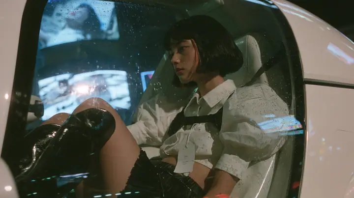 seen from outside through the rear side window of a white driverless robotaxi at night, a young woman with a glossy black blunt bob with heavy bangs and one clay-orange streak, a white cropped puff-sleeve shirt, a…