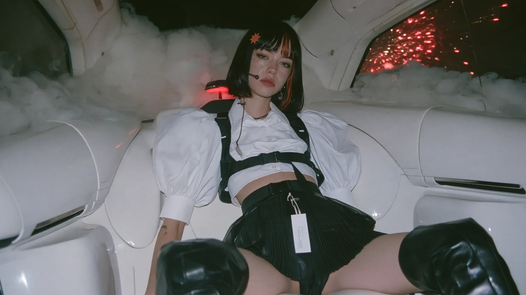 the back seat of a driverless white robotaxi at night, thick white smoke outside the windows, red firework sparks bursting against the glass, a young Caucasian American woman with pale skin and light freckles, a…