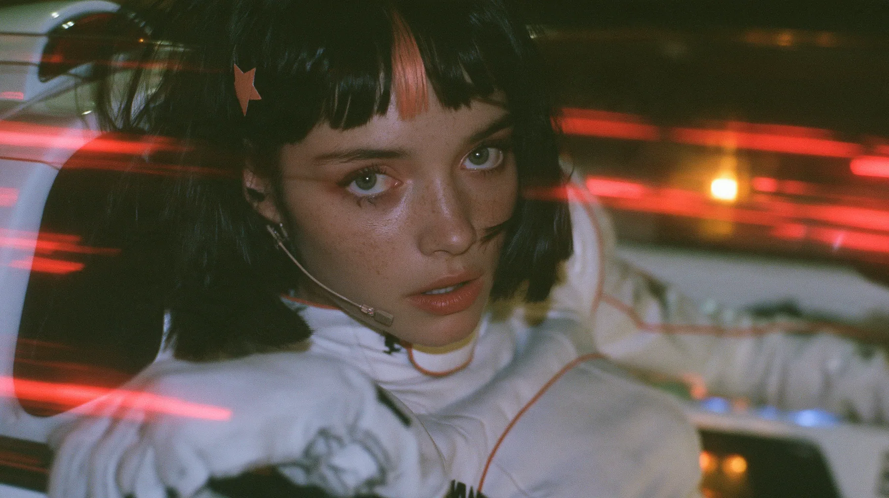 close-up, a 28-year-old Caucasian American woman with a grown-up angular face, defined cheekbones and a strong jawline, pale skin and light freckles, a glossy black blunt jaw-length bob with heavy straight bangs and…