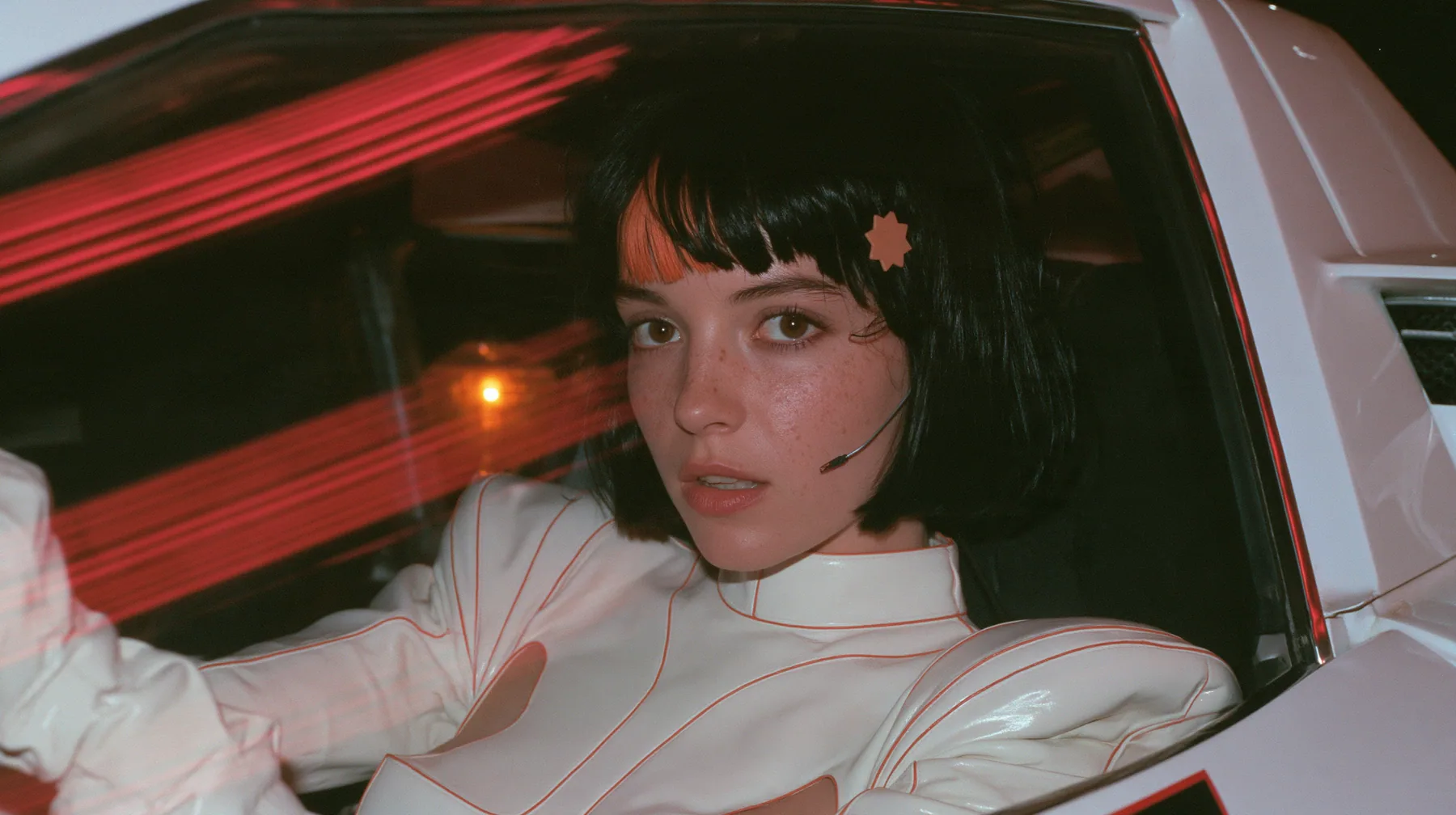 close-up, a 28-year-old Caucasian American woman with a grown-up angular face, defined cheekbones and a strong jawline, pale skin and light freckles, a glossy black blunt jaw-length bob with heavy straight bangs and…