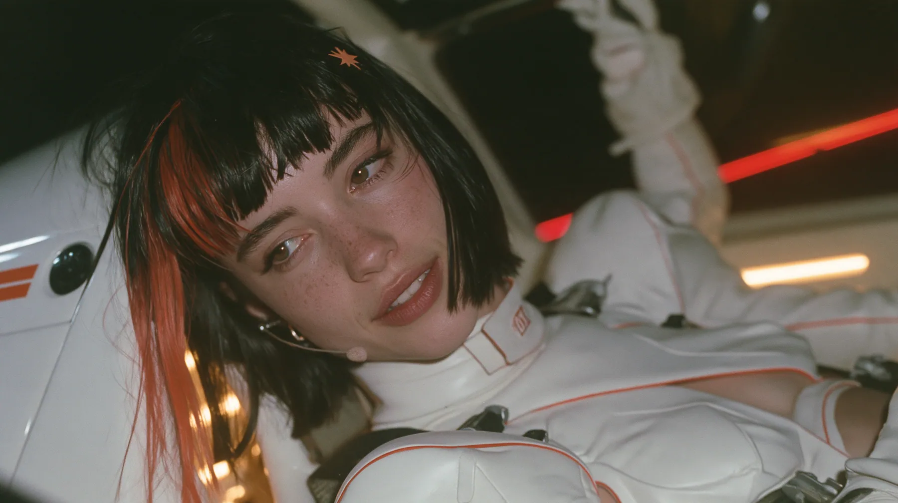 close-up, a 28-year-old Caucasian American woman with a grown-up angular face, defined cheekbones and a strong jawline, pale skin and light freckles, a glossy black blunt jaw-length bob with heavy straight bangs and…