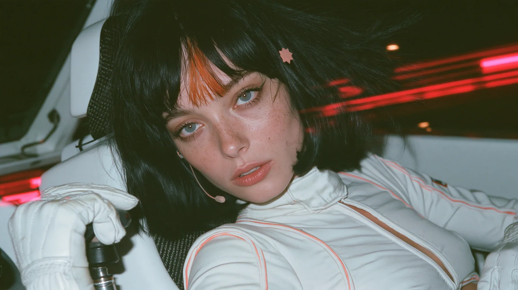 close-up, eye level, a 28-year-old Caucasian American woman with a grown-up angular face, defined cheekbones and a strong jawline, pale skin and light freckles, a glossy black blunt jaw-length bob with heavy straight…