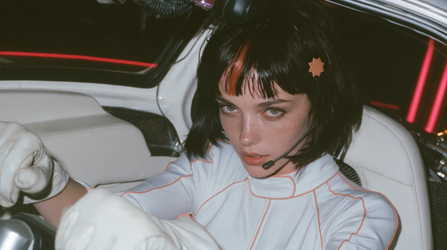 close-up of her two white-gloved hands on the yoke, her chin and headset microphone at the top edge of the frame, a 28-year-old Caucasian American woman with a grown-up angular face, defined cheekbones and a strong…