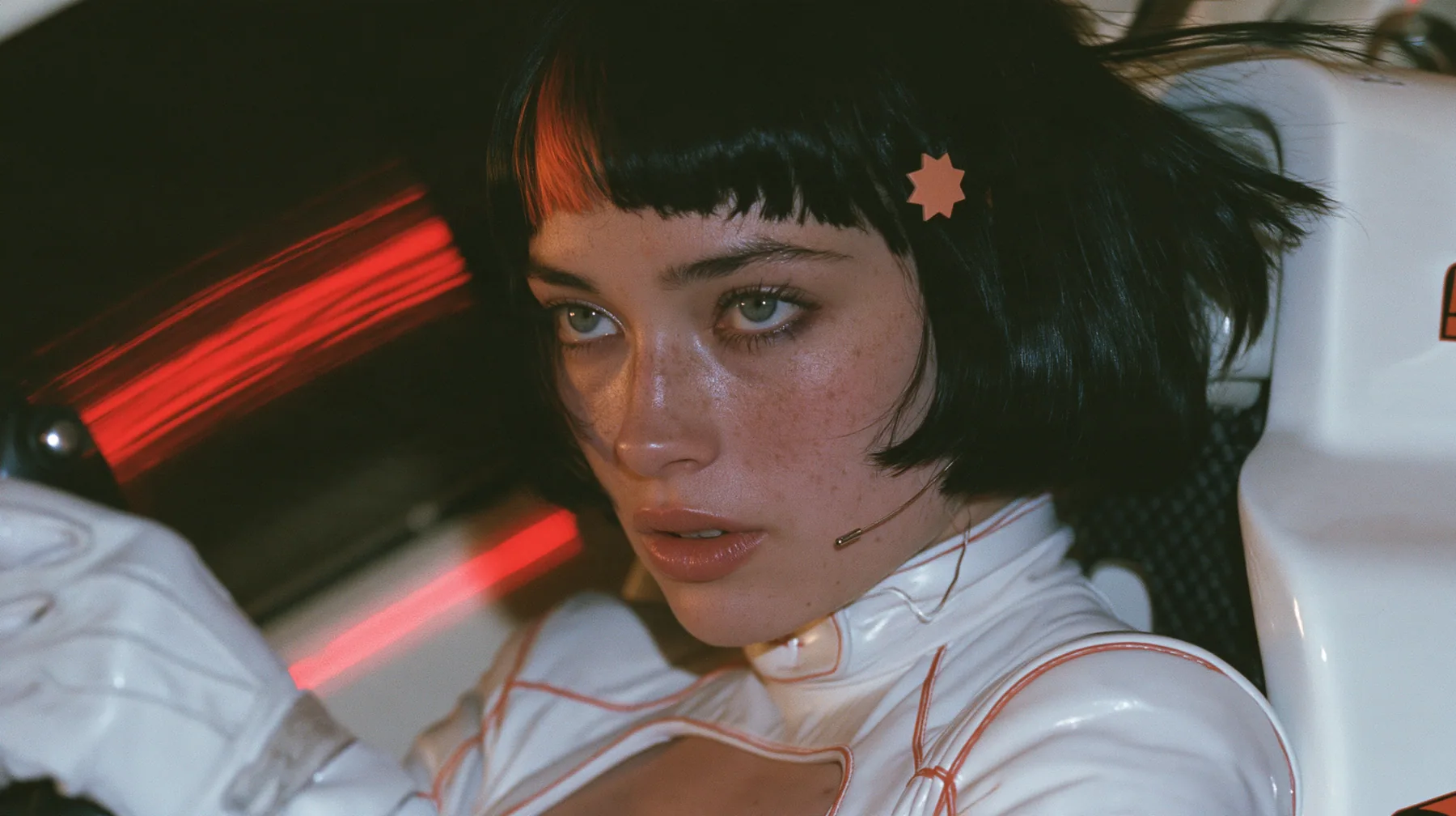 profile close-up, a 28-year-old Caucasian American woman with a grown-up angular face, defined cheekbones and a strong jawline, pale skin and light freckles, a glossy black blunt jaw-length bob with heavy straight…