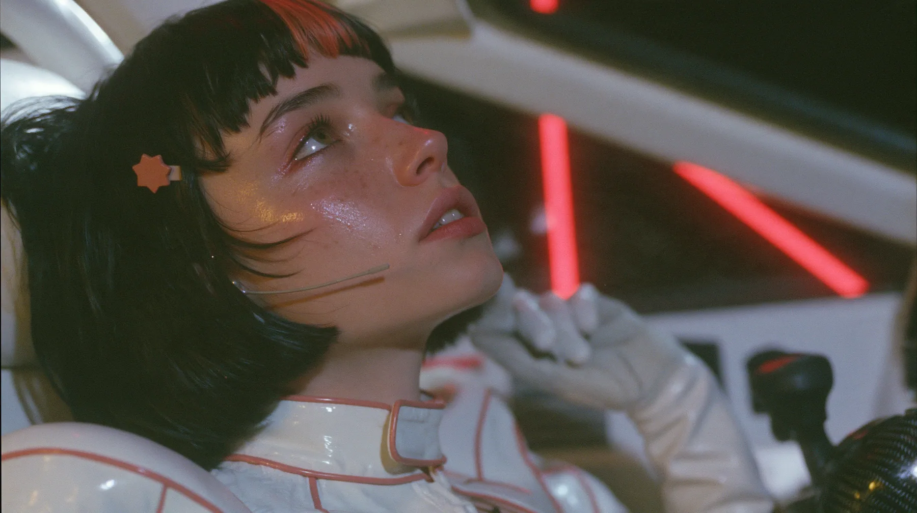 profile close-up, a 28-year-old Caucasian American woman with a grown-up angular face, defined cheekbones and a strong jawline, pale skin and light freckles, a glossy black blunt jaw-length bob with heavy straight…