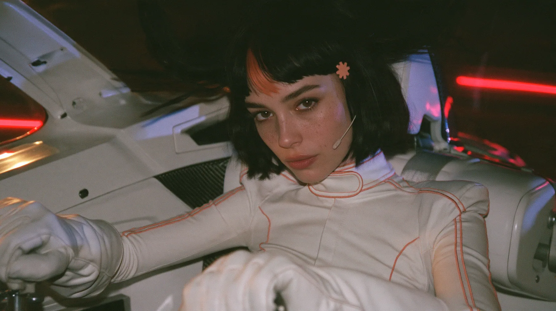 medium shot from the passenger side, a 28-year-old Caucasian American woman with a grown-up angular face, defined cheekbones and a strong jawline, pale skin and light freckles, a glossy black blunt jaw-length bob…
