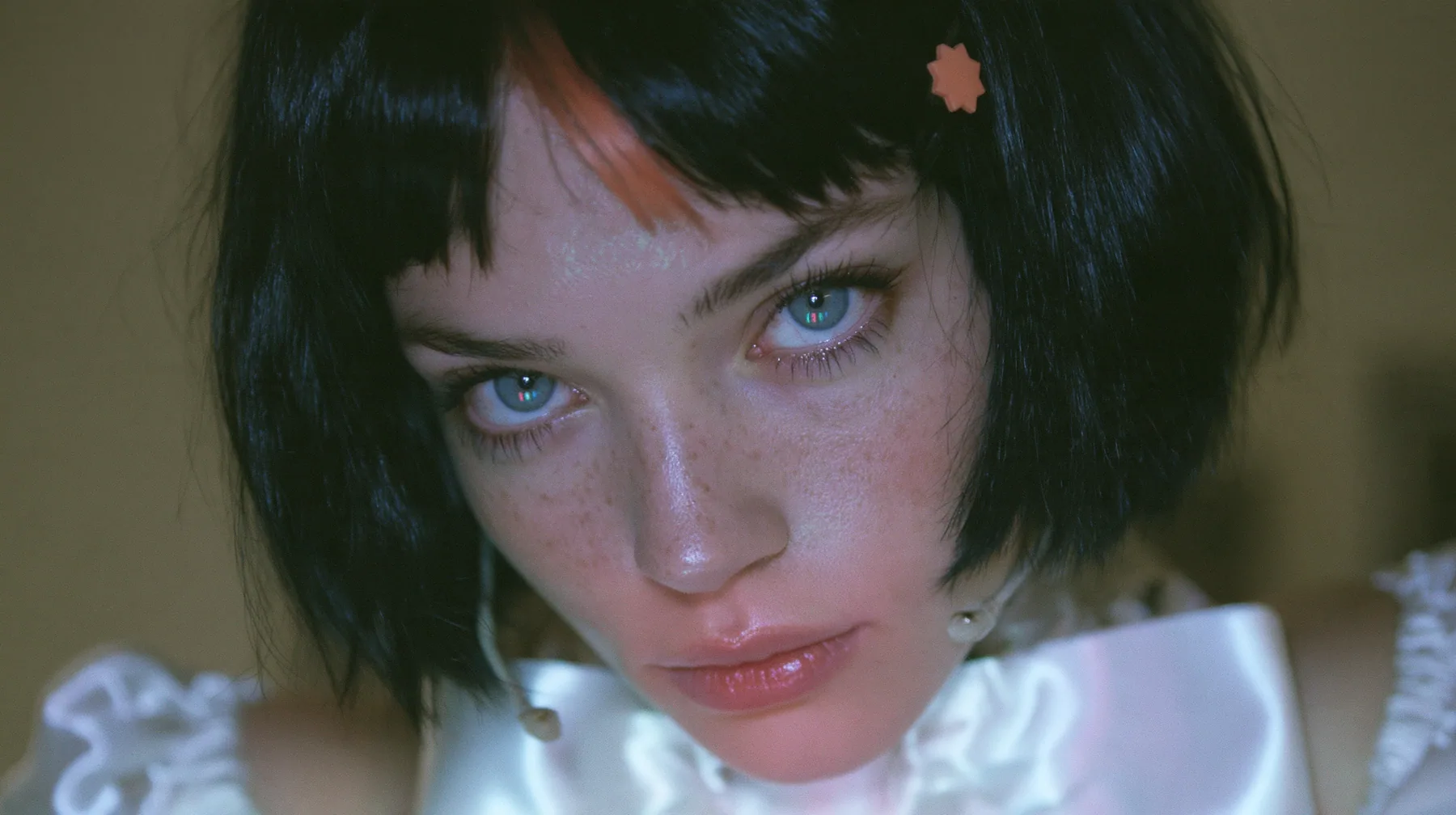 close-up, a 28-year-old Caucasian American woman with a grown-up angular face, defined cheekbones and a strong jawline, pale skin and light freckles, a glossy black blunt jaw-length bob with heavy straight bangs and…