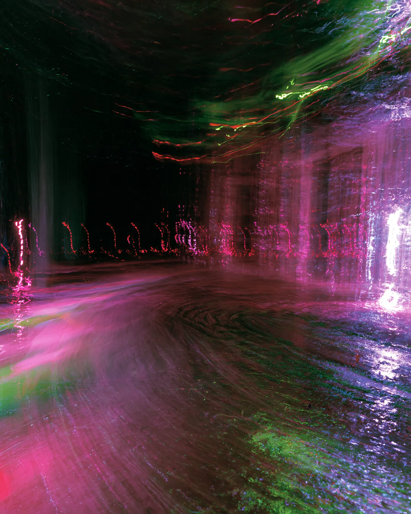 a long-exposure photograph of magenta and acid-green light trails over a dark dance floor, smeared, euphoric, no text, no letters, no logos