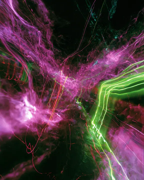 a long-exposure photograph of magenta and acid-green light trails over a dark dance floor, smeared, euphoric, no text, no letters, no logos