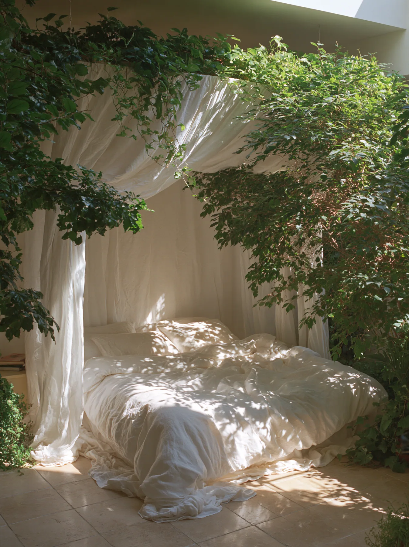 a dreamy bedroom with a linen canopy bed and trailing plants, soft morning light, no text, no letters, no logos