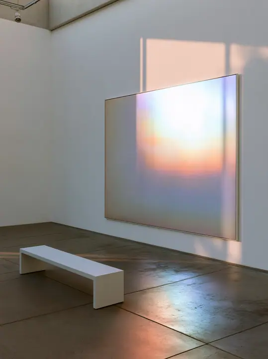 an abstract gradient painting in a white gallery, one bench, soft light, no text, no letters, no logos