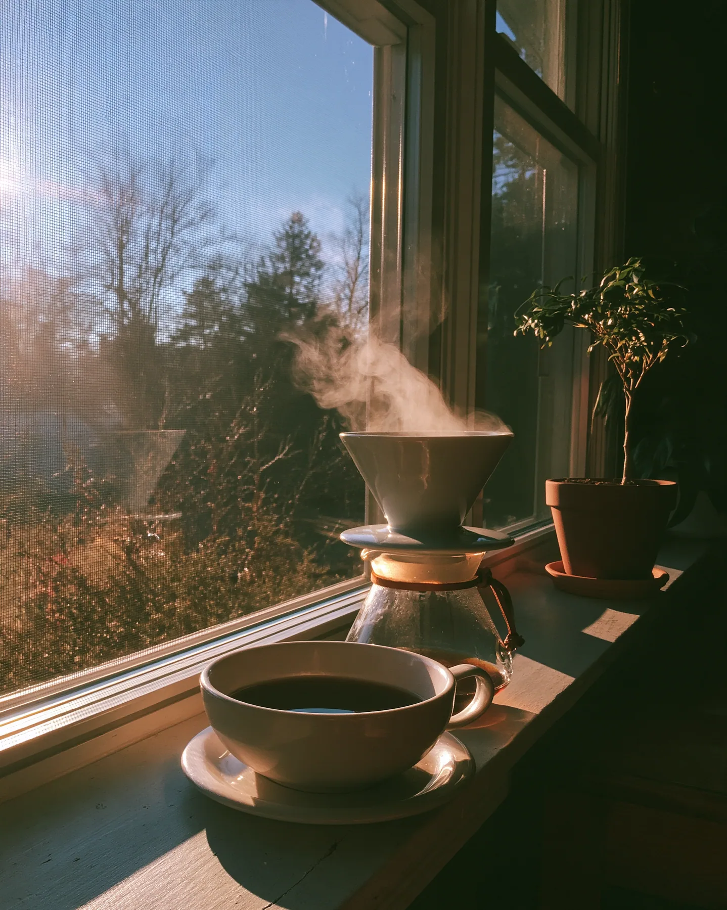 a ceramic pour-over coffee set on a windowsill at dawn, steam, no text, no letters, no logos