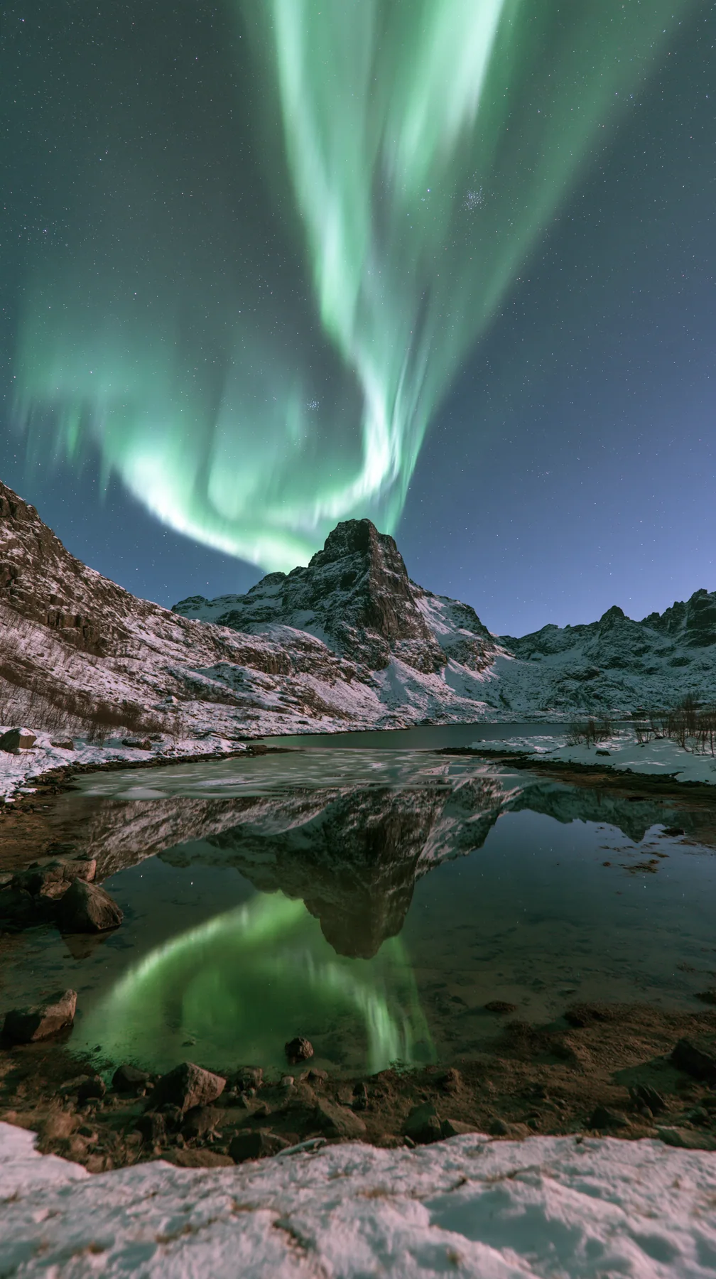 the northern lights rippling green and violet over a snowy mountain lake, no text, no letters, no logos